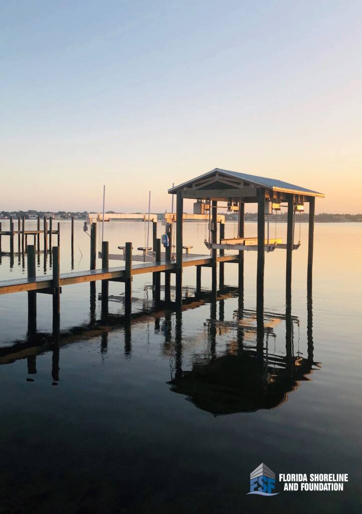 Boat house and boat dock on Siesta Key in Sarasota with Trex decking and a 30,000-pound DECO Concept CRS boat lift installed by Florida Shoreline and Foundation.